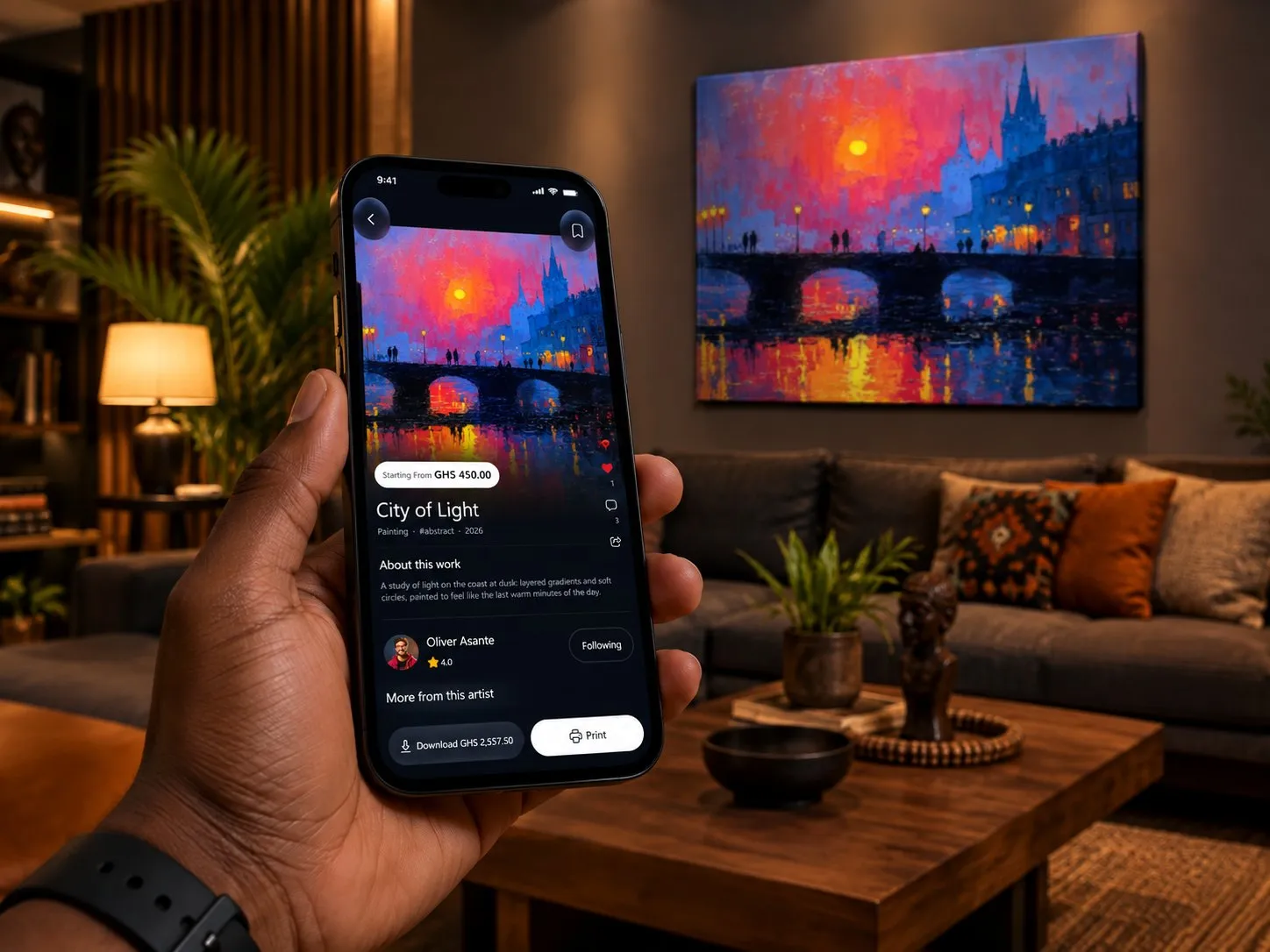 A hand holding a phone showing the City of Light artwork in Melovibx, with the same painting printed on the living room wall behind